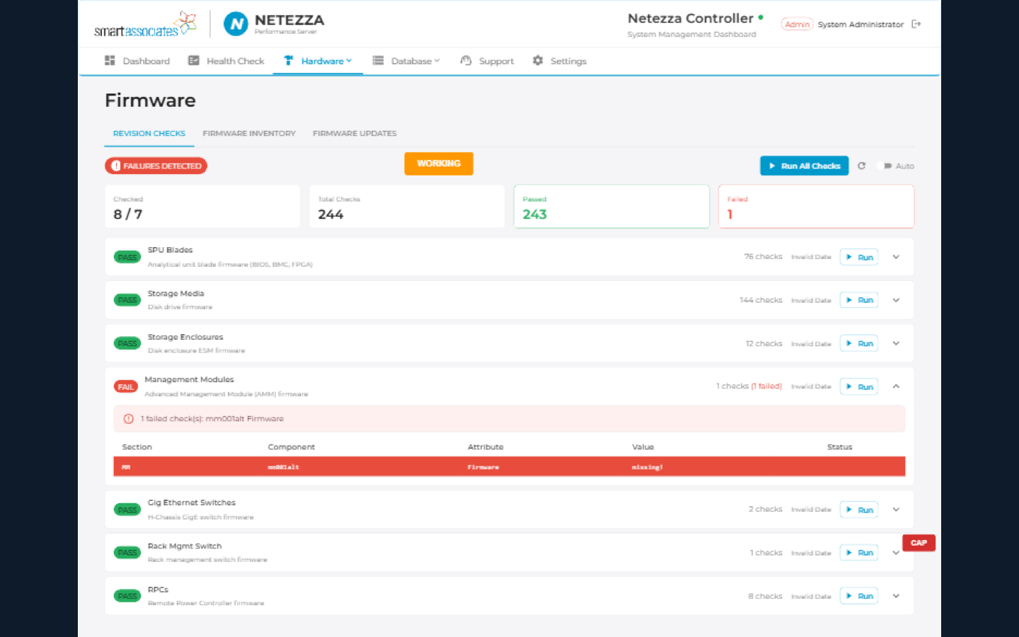 Firmware revision checks showing pass/fail status across SPU blades, storage media, enclosures, and management modules